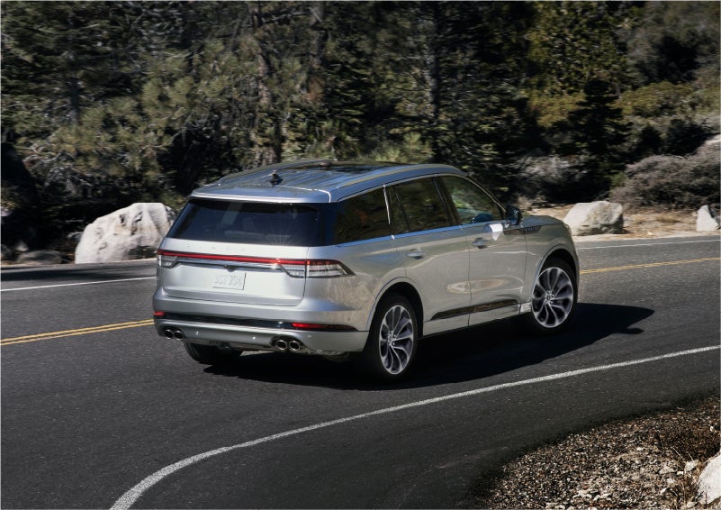 A 2023 Lincoln Aviator® Grand Touring model is shown being driven on a tight turn of a mountain road | Thornhill Lincoln in Chapmanville WV