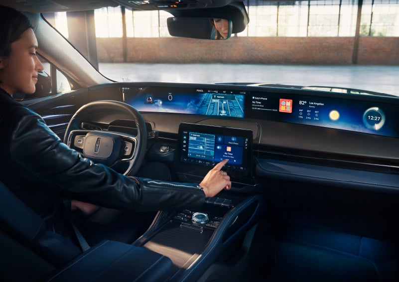The driver of a 2024 Lincoln Nautilus® SUV interacts with the center touchscreen. | Thornhill Lincoln in Chapmanville WV
